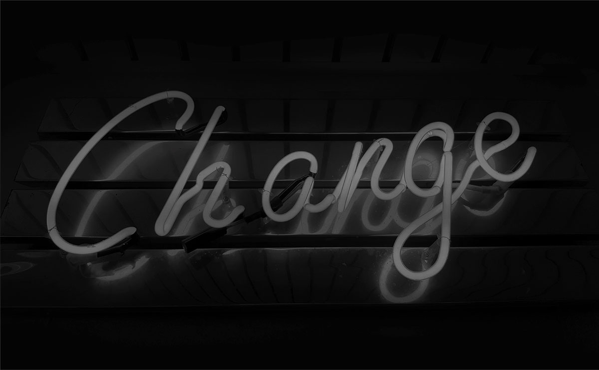 Desaturated neon sign reads 'change'