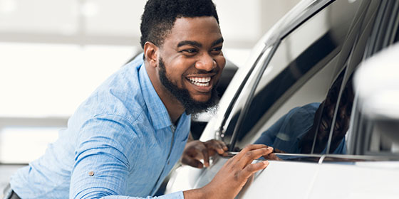 Happy Man Looking at New Car