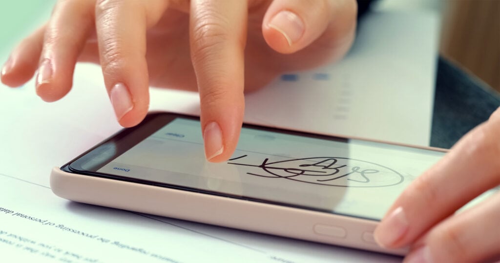 Woman signing a contract on phone