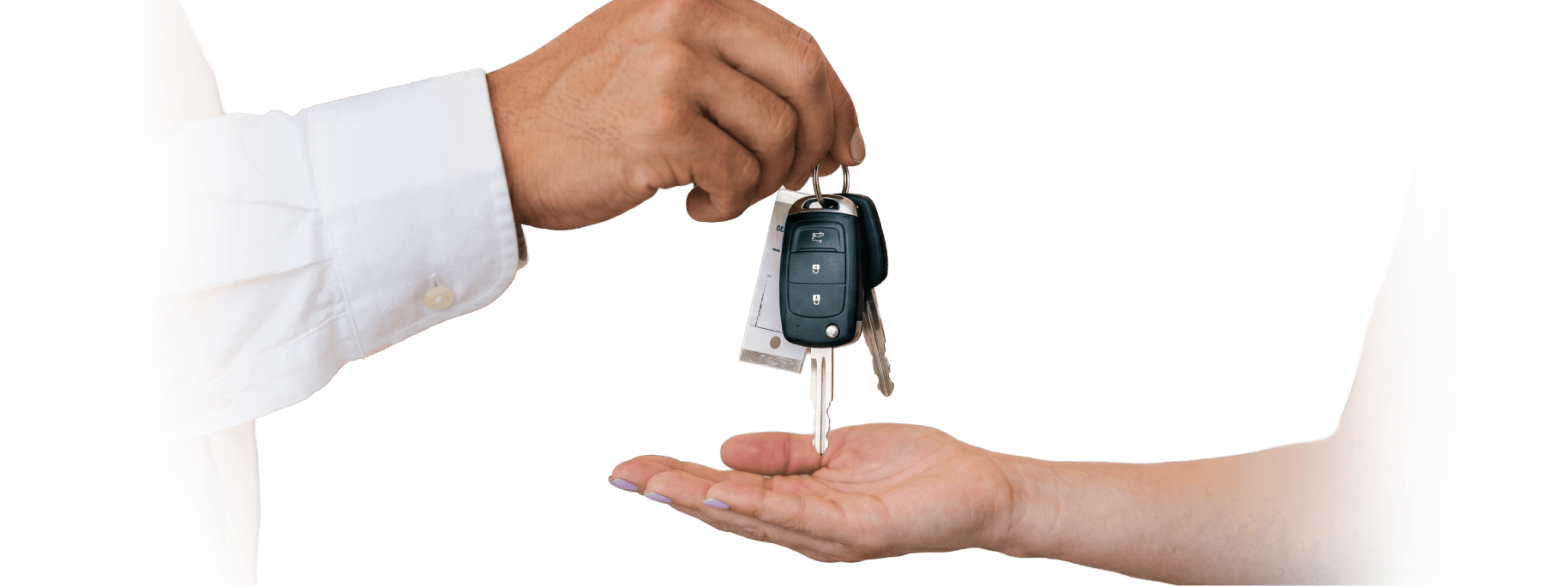 Person handing over car keys to another person for engagement or rental.